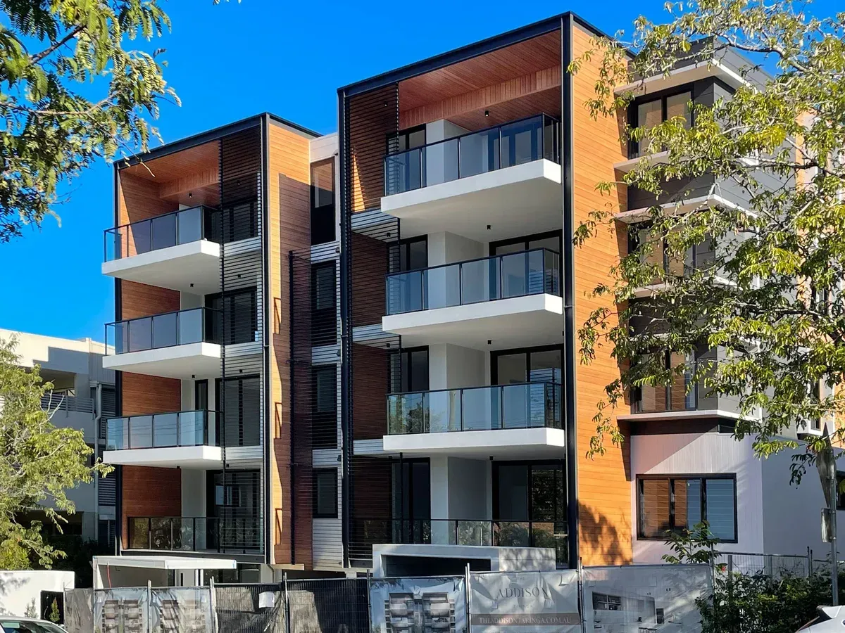 A large apartment building with a lot of windows and balconies