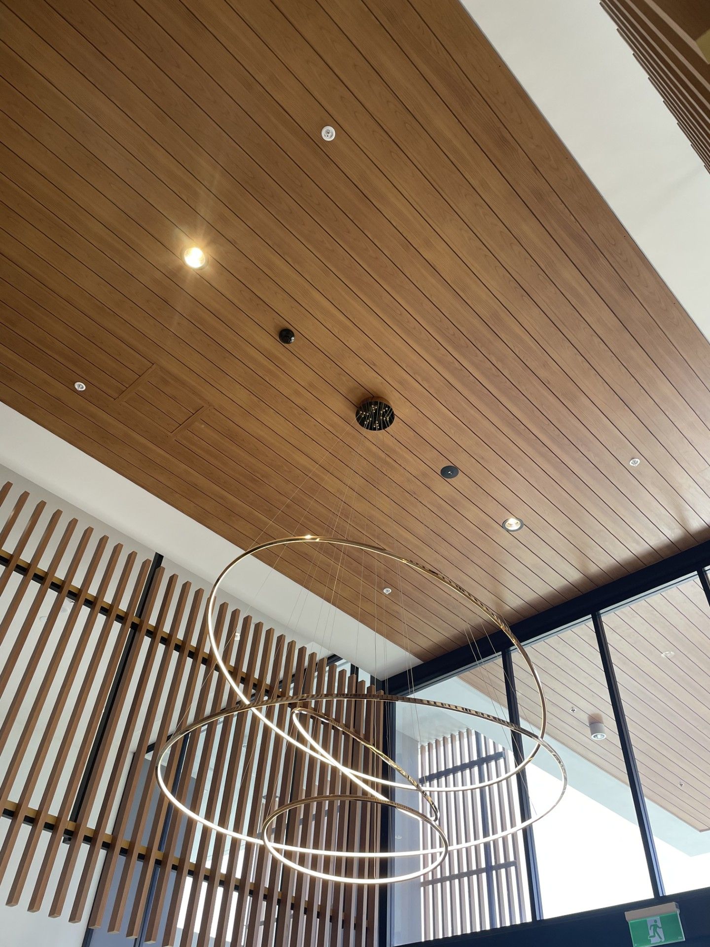 A wooden ceiling with a chandelier hanging from it