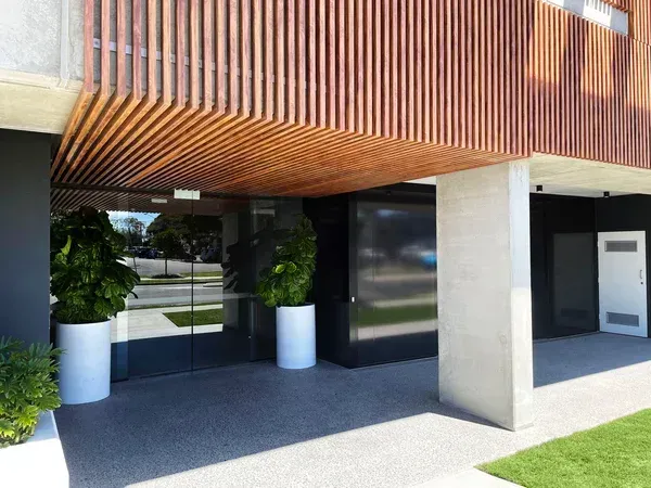 A building with a lot of windows and planters in front of it