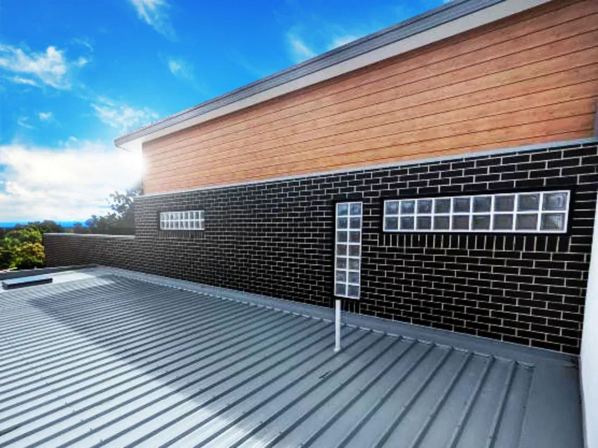 A brick building with a metal roof and a brick wall.