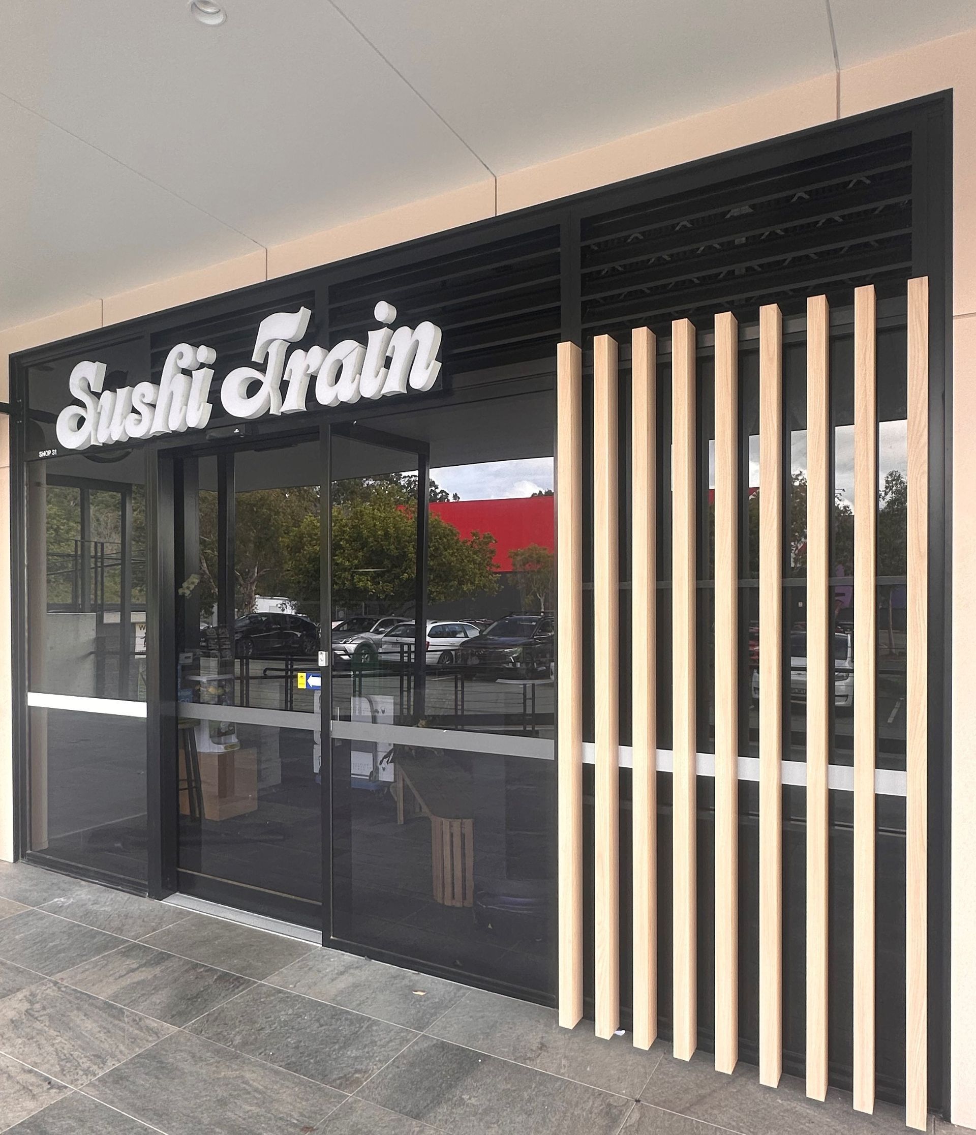 A restaurant with a sign that says sushi train on it