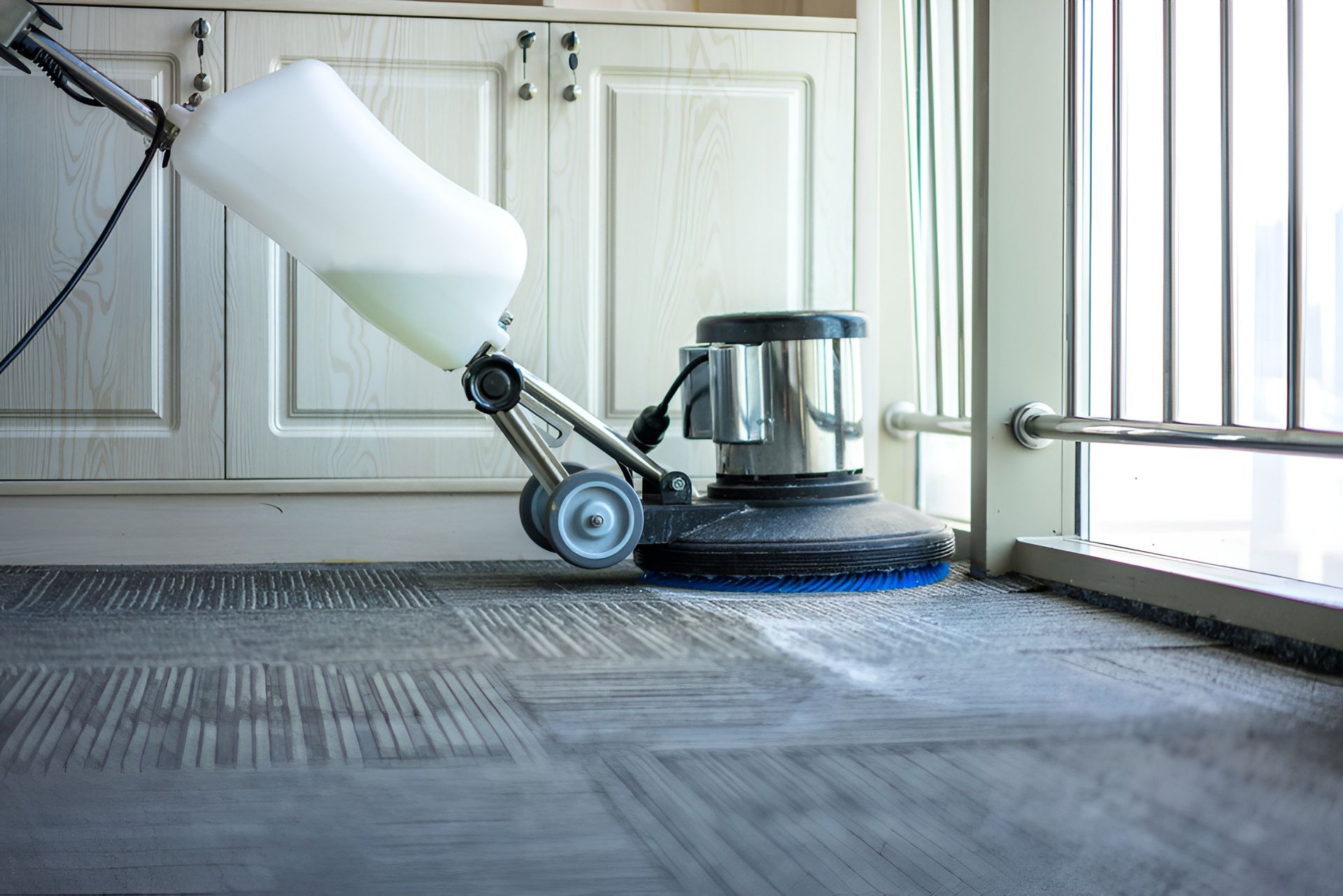 Floor Cleaning Machine Scrubbing a Carpet Near a Window — Clean Coast Carpet Cleaning in Port Stephens, NSW