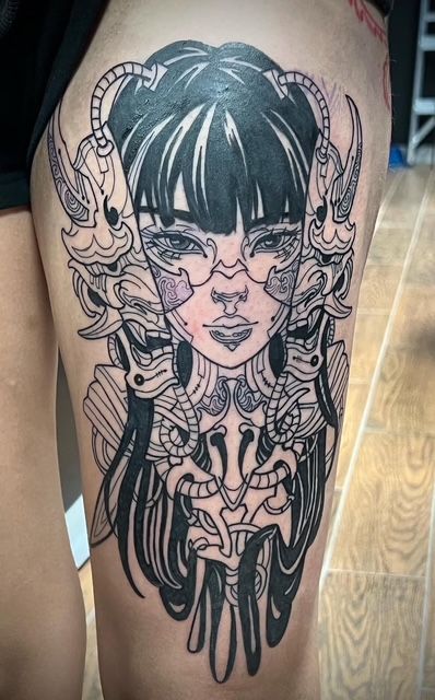 Tattoo of a detailed wolf head on a person's arm, showcasing gray fur and yellow eyes.