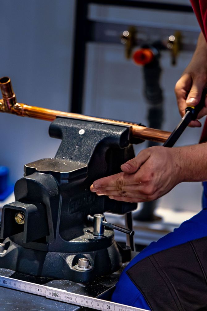Plumber working on copper pipework for a heating installation