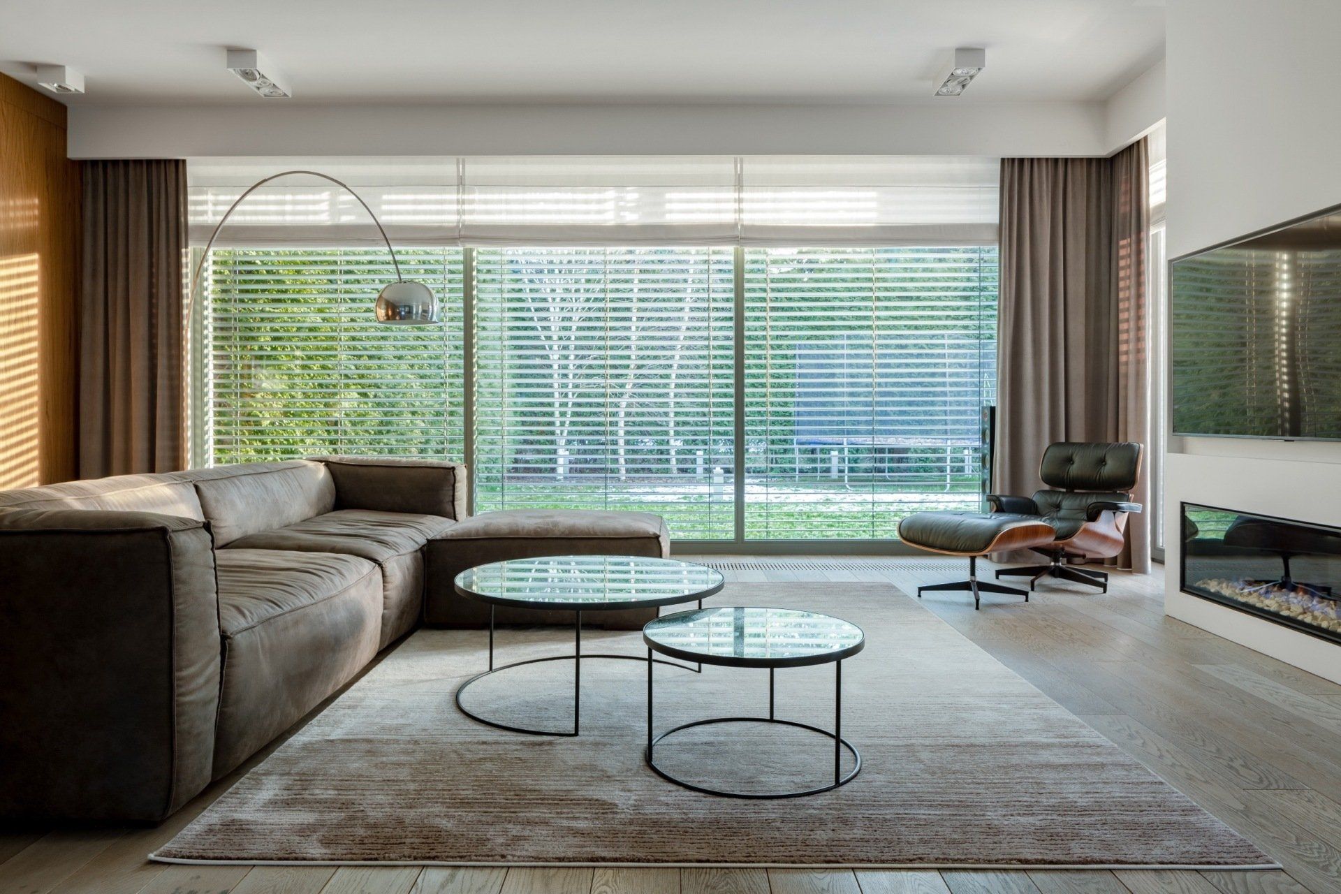 A living room with a couch , two coffee tables and a fireplace.