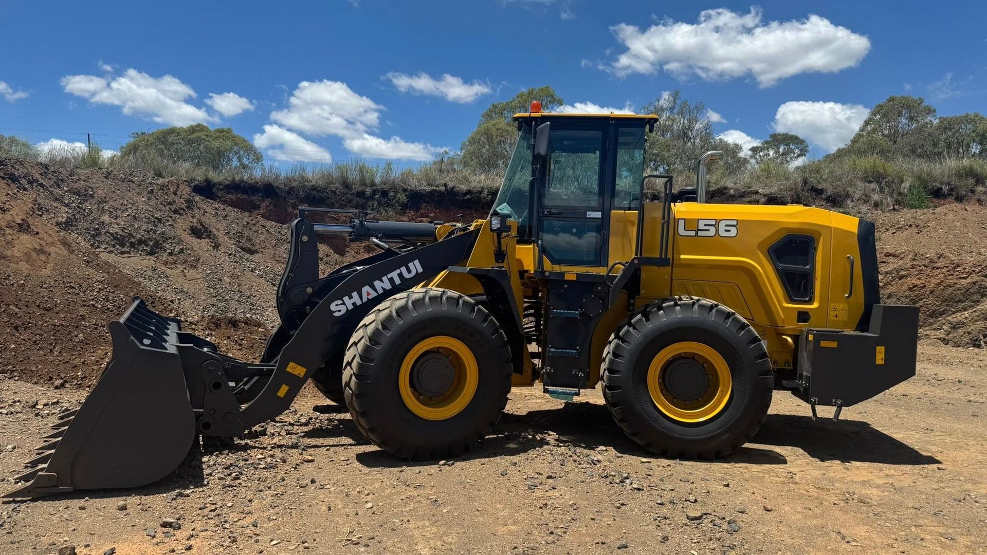 Yellow Backhoe on A Construction Site, Scooping Dirt — Shantui QLD in Dalby, QLD