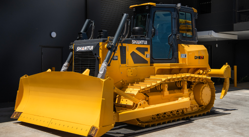 Yellow bulldozer parked in front of a dark building — Shantui QLD in Kingsthorpe, QLD