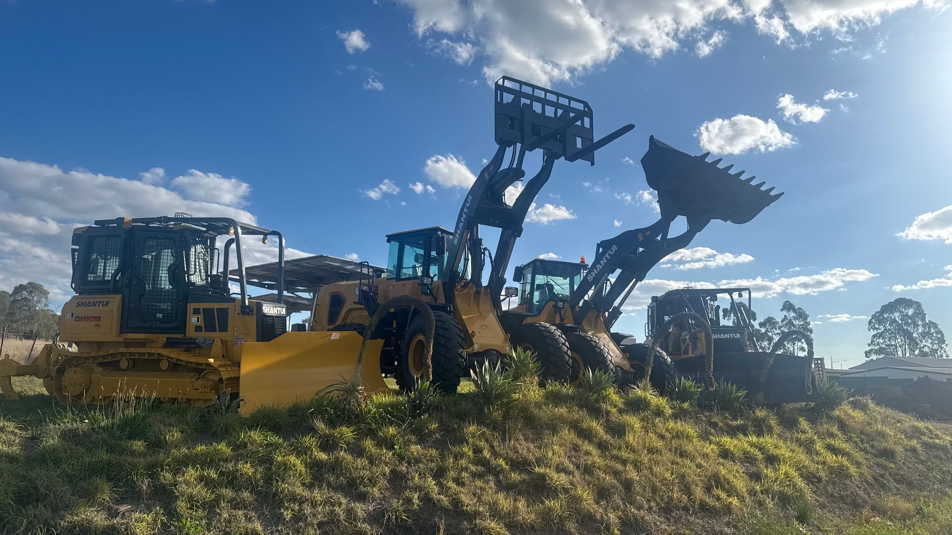 Yellow Construction Vehicles Parked Outside — Shantui QLD in Kingsthorpe, QLD