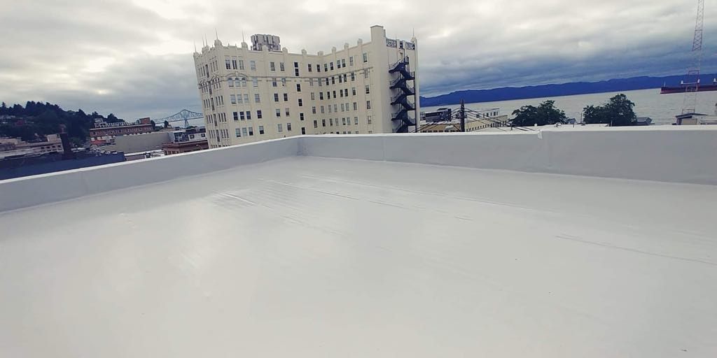 Duro-Last Single-Ply Membrane Roof System with a white building and cloudy sky in the distance