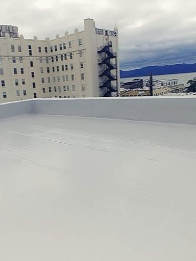 Commercial businesses rooftop with a beige building and cloudy sky in the background