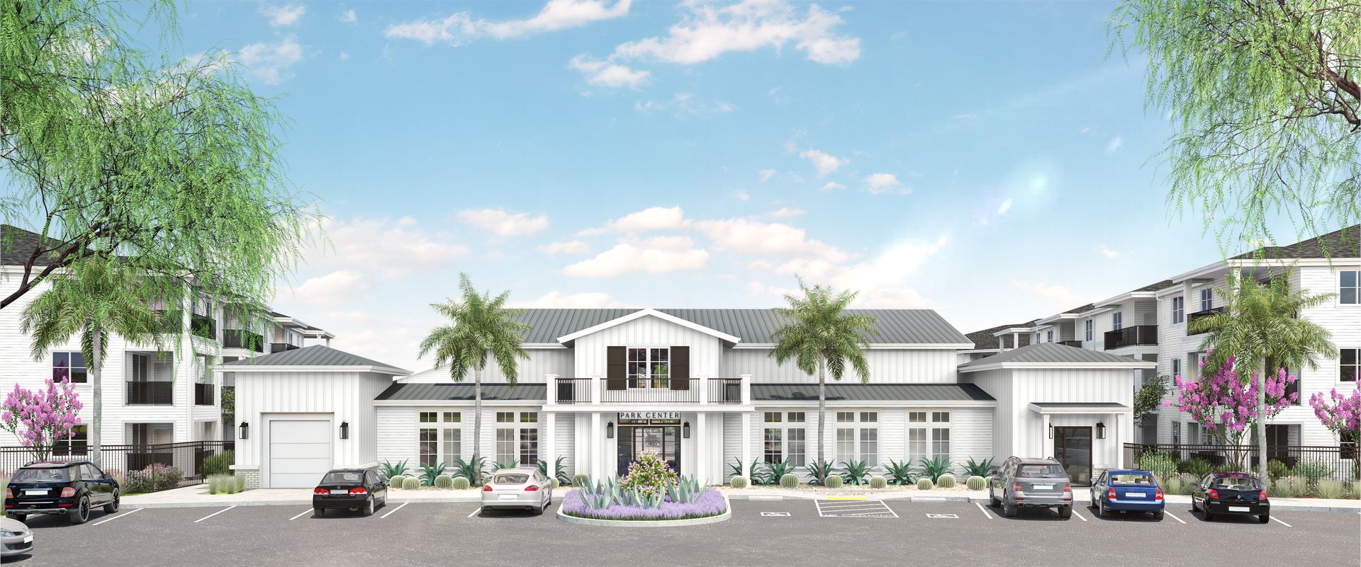 a white community building with two palm trees