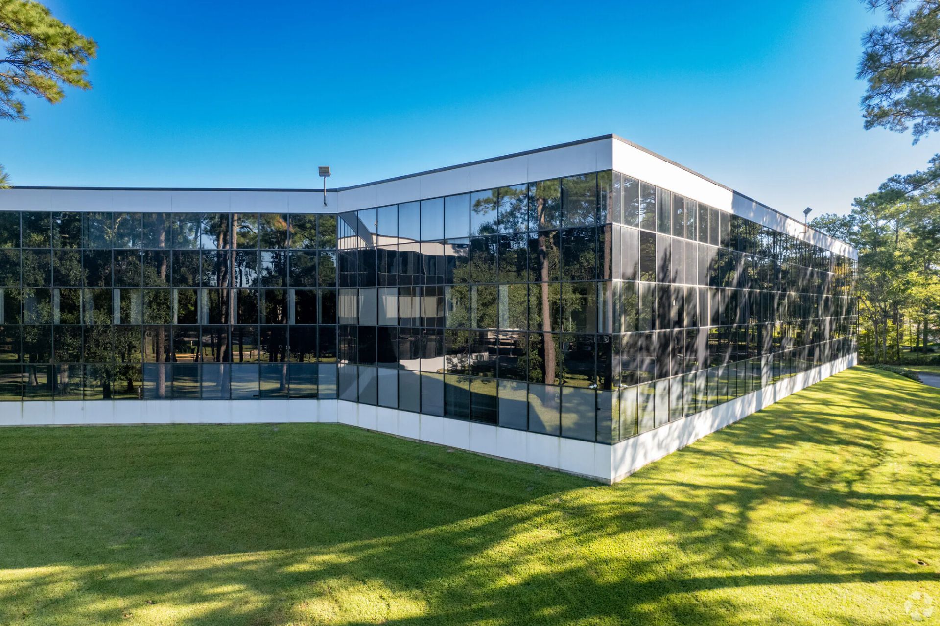 Office building exterior with trees and landscaping.