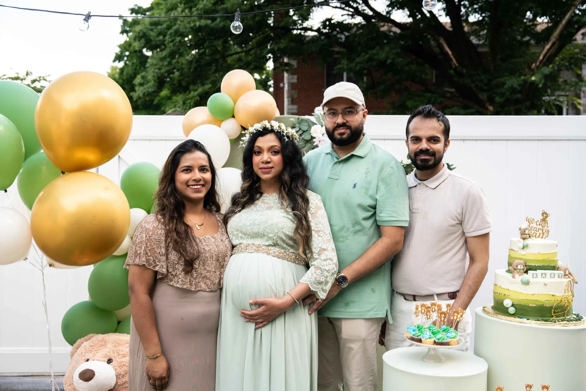 A group of people are posing for a picture at a baby shower.