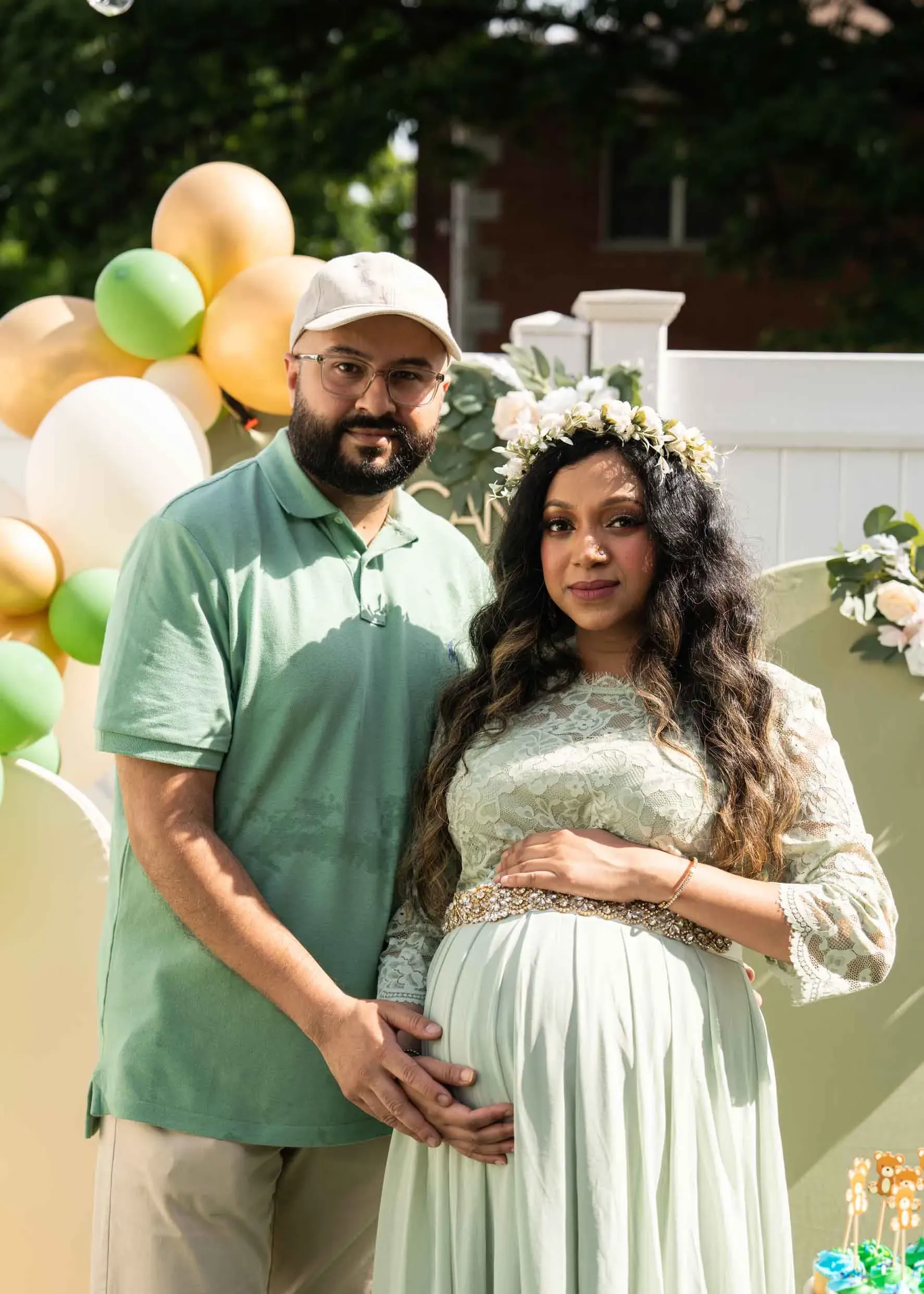 A man and a pregnant woman are posing for a picture at a baby shower.