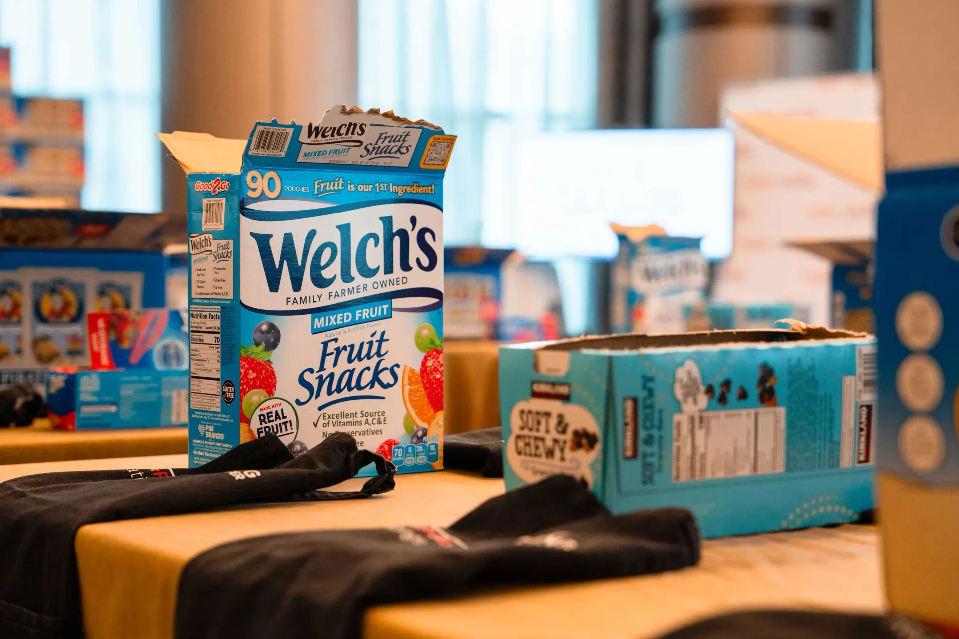 A box of welch 's fruit snacks is sitting on a table.