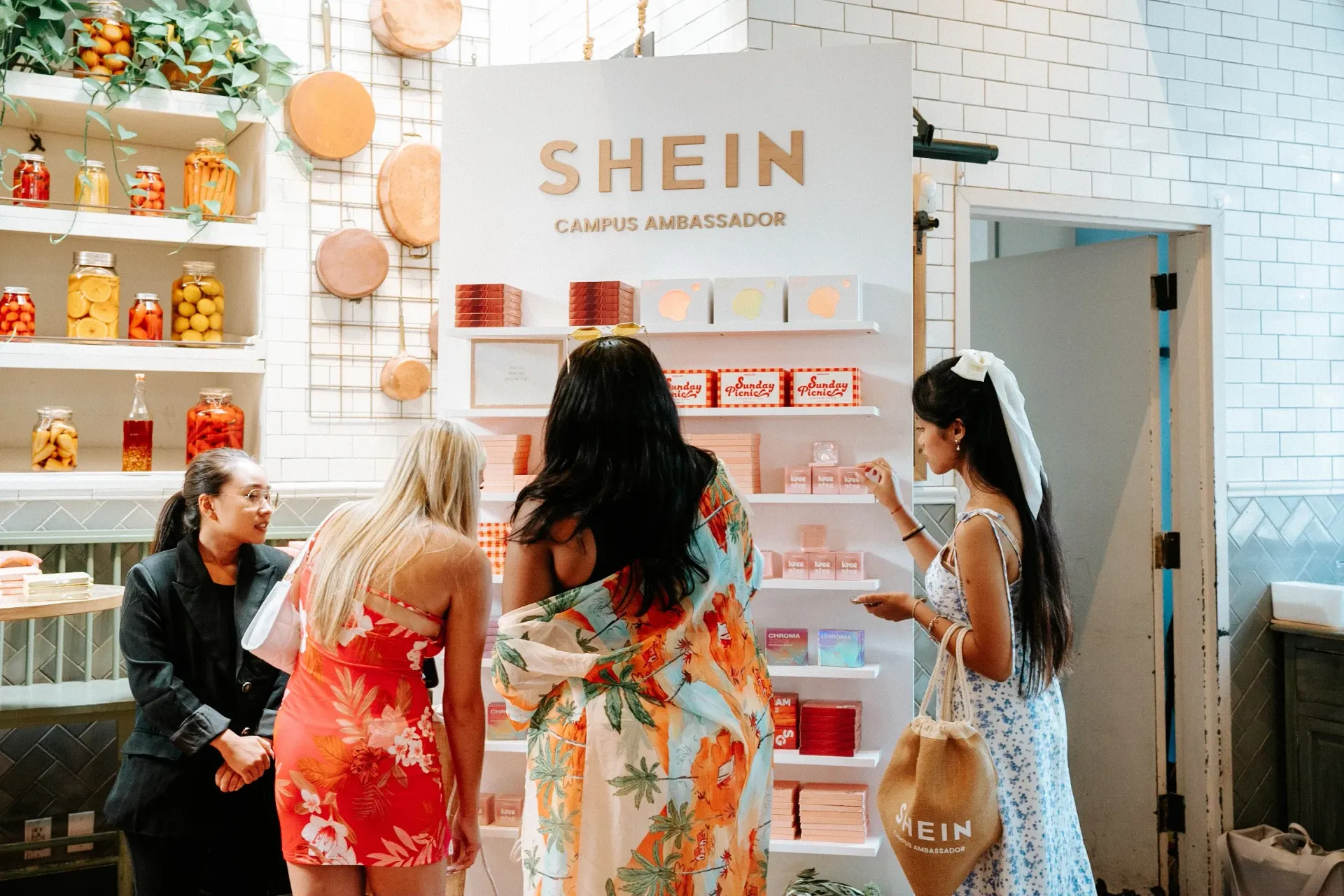 A group of women are standing in front of a shein store.