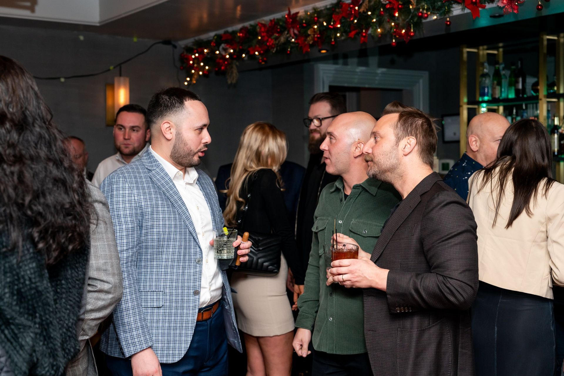 Guests talking over drinks at a corporate holiday party