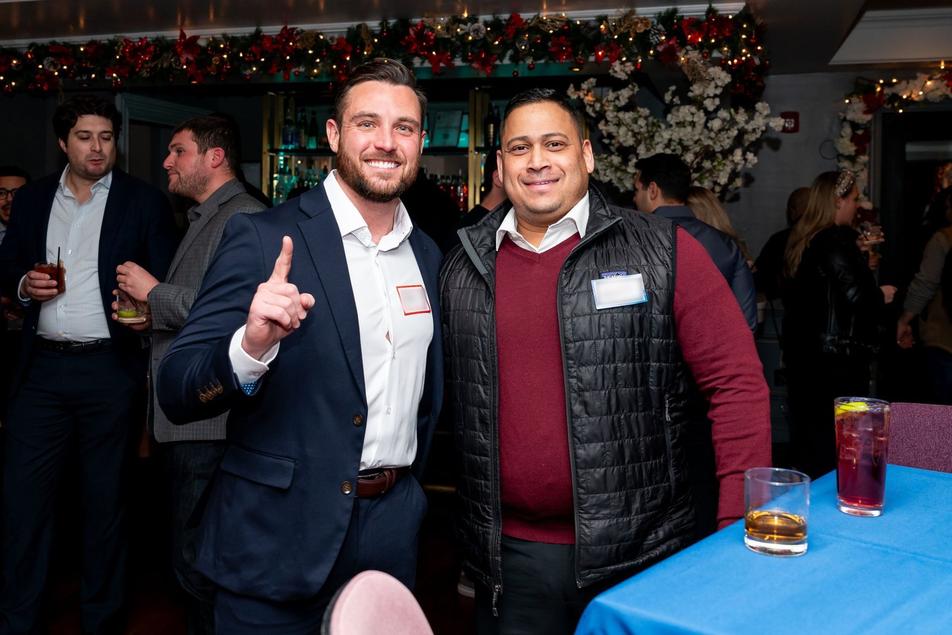 Two guests smiling for a photo at a corporate holiday party