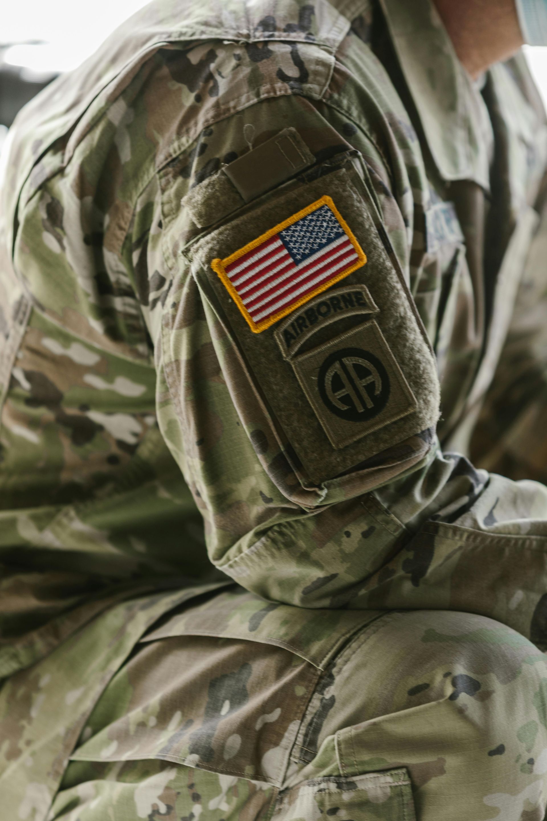 Close-up of a soldier in camouflage with a U.S. flag patch on the sleeve
