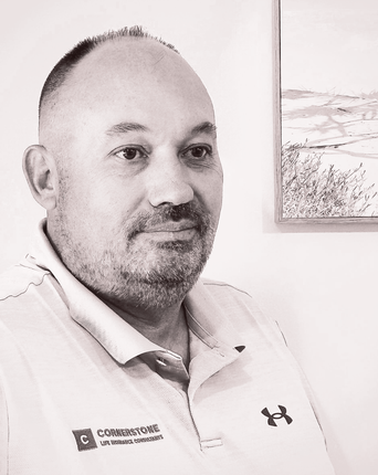Company Director photo of  man with a short beard wearing a collared athletic shirt with a logo