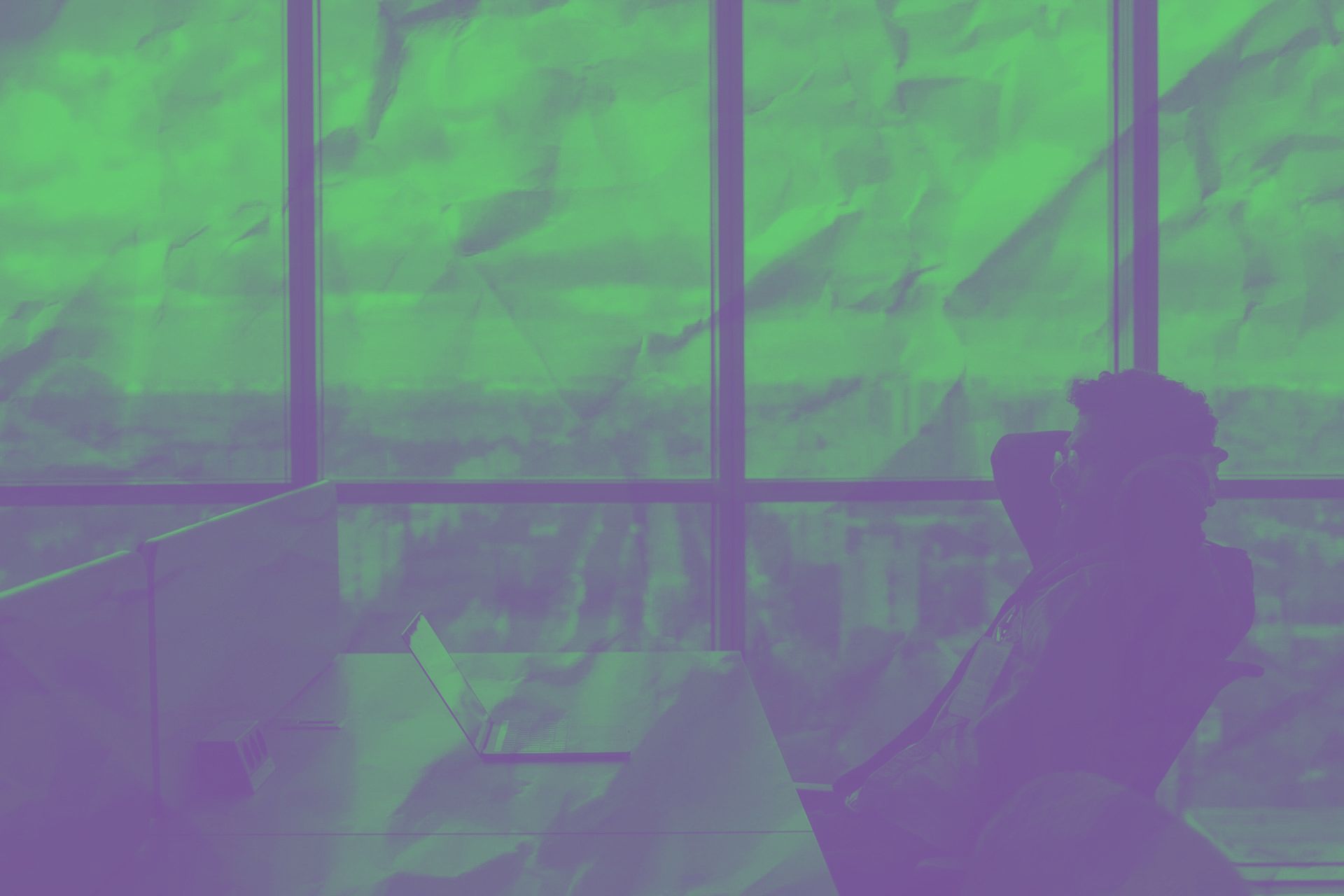 a business owner thinking about how much cyber insurance he needs with green and purple background
