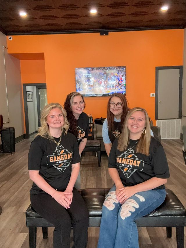 Four people in black