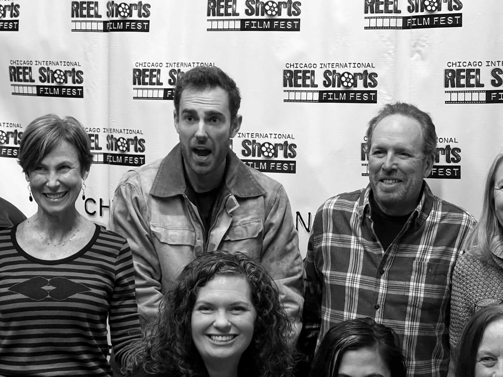 Group of people smiling at a 