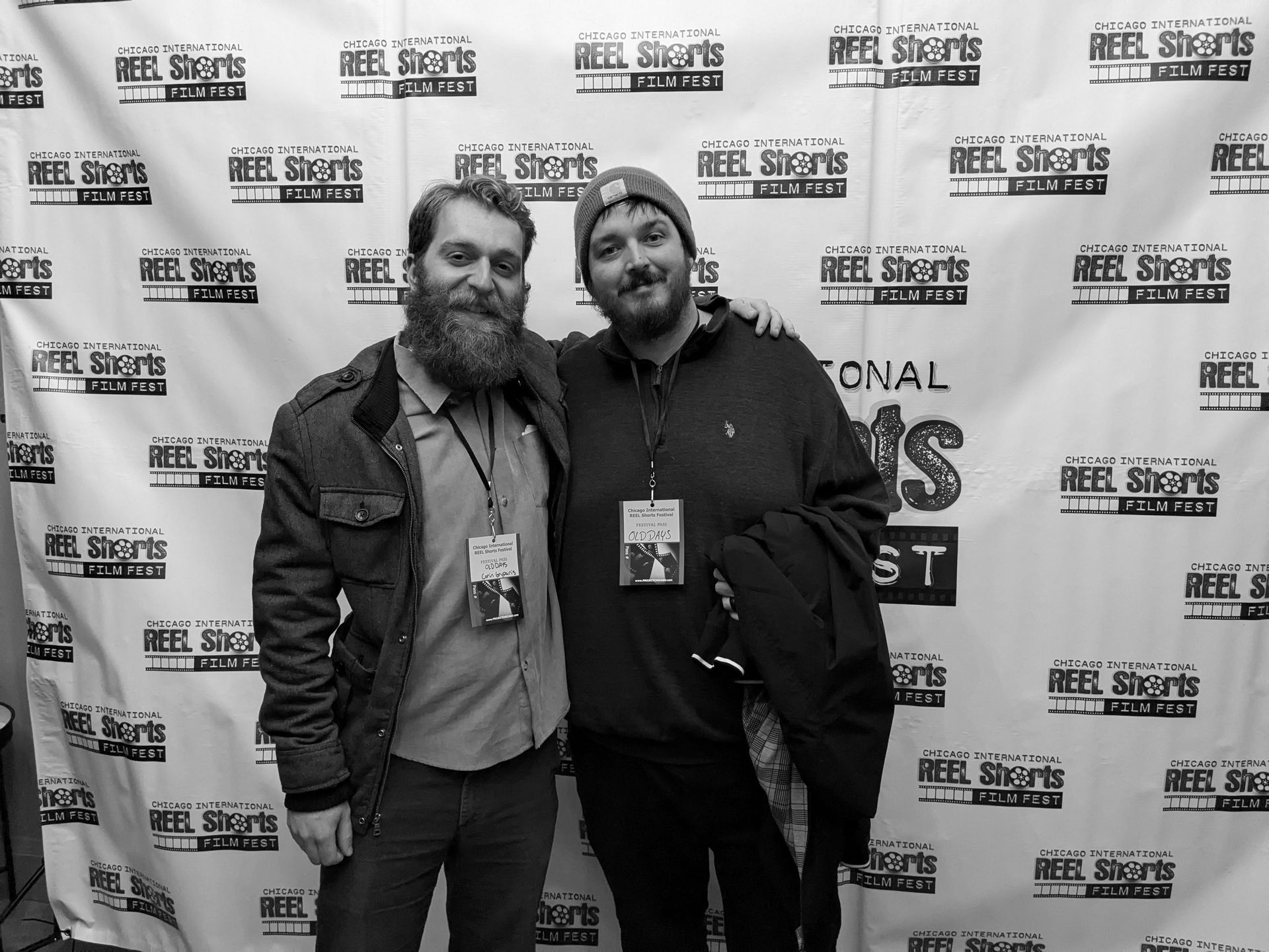 Two men pose together at an event with a 