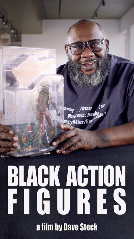 Man holding a boxed action figure, in front of film title