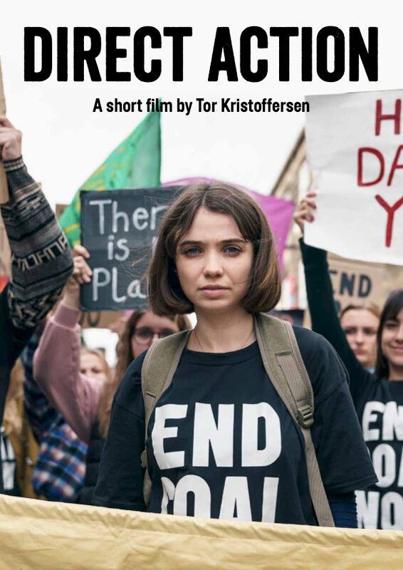 A young woman with a backpack stands at a protest. She wears a 