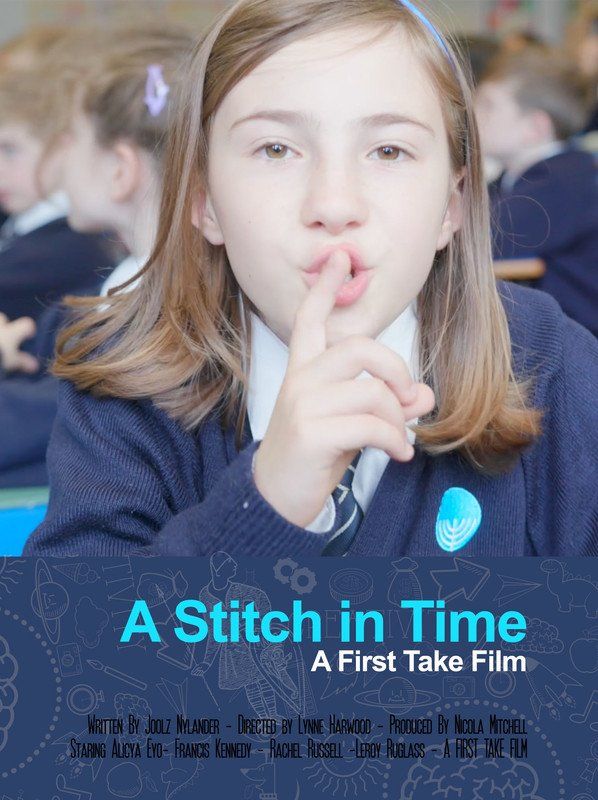 A young girl in a school uniform with finger to lips, whispering in a classroom.