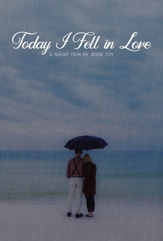 Couple under black umbrella on beach, overcast sky, title 