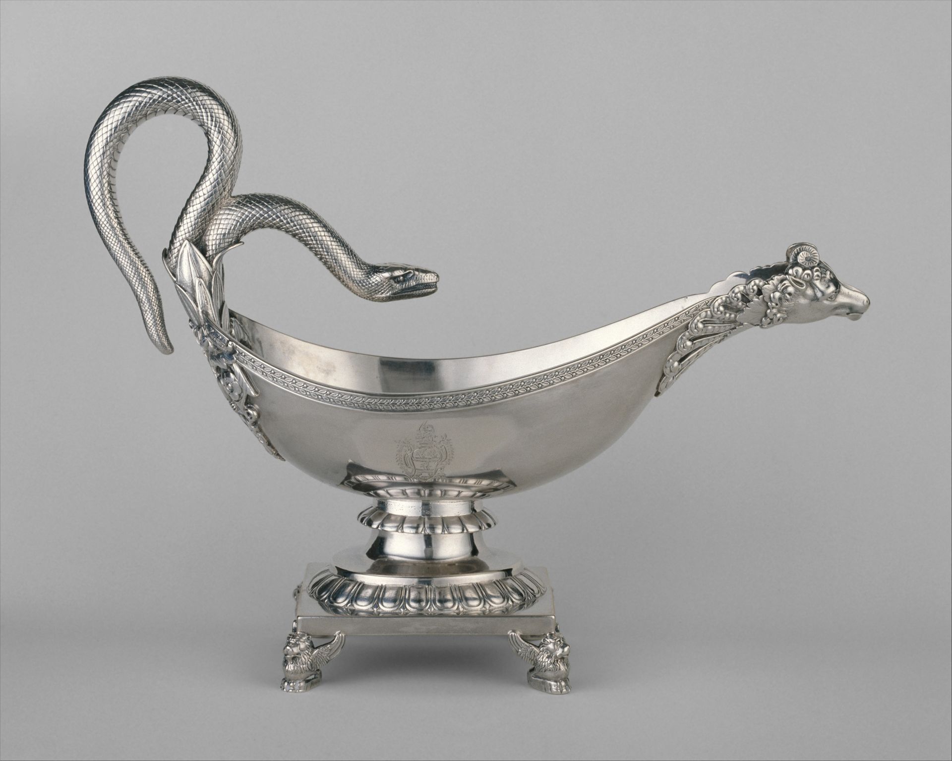 Quastel Associates | Silver gravy boat with a snake-shaped handle and spout, ornate pedestal base.