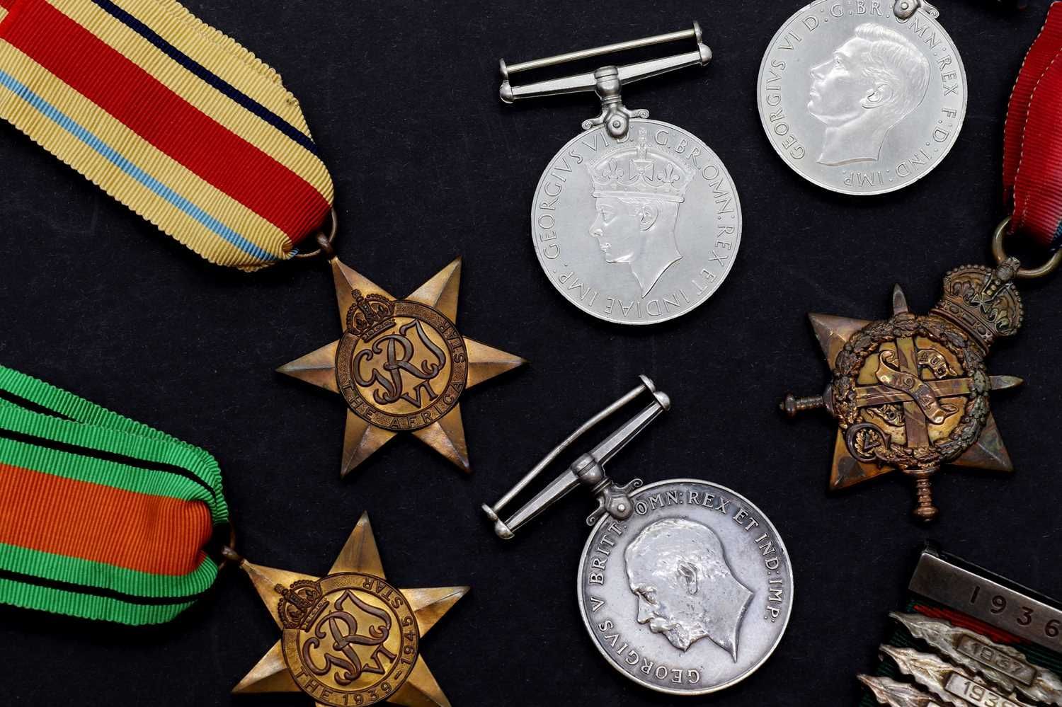 Quastel Associates | Collection of historical medals on a black background, with colorful ribbons and star-shaped designs.