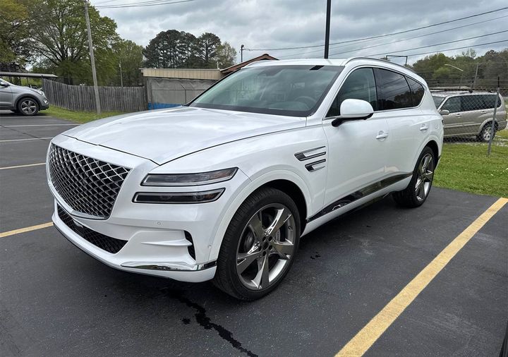 White GV 80 parked in our parking lot | Windham Bodyshop