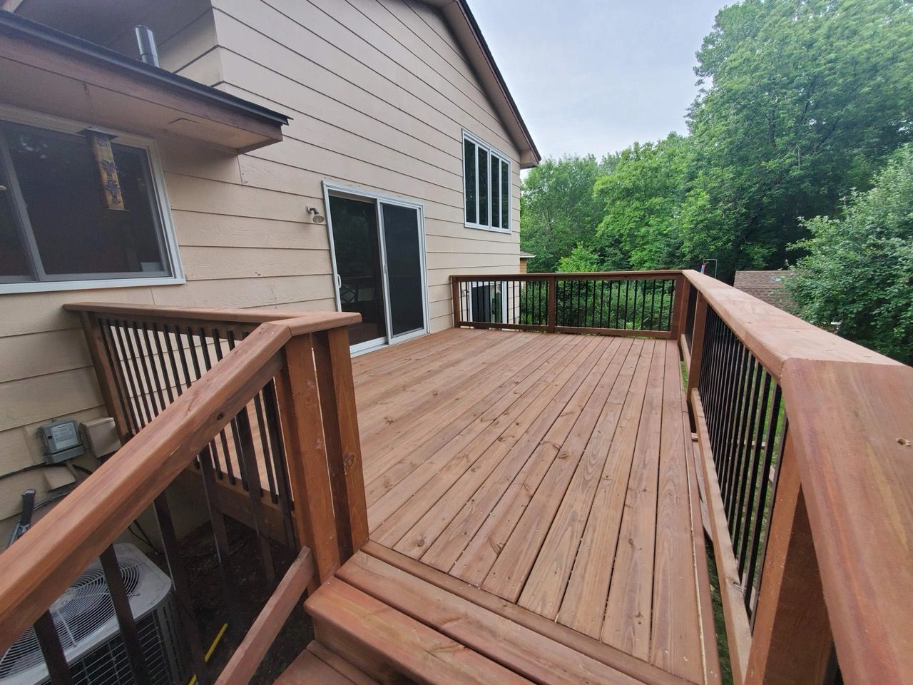 A large wooden deck with stairs leading up to it