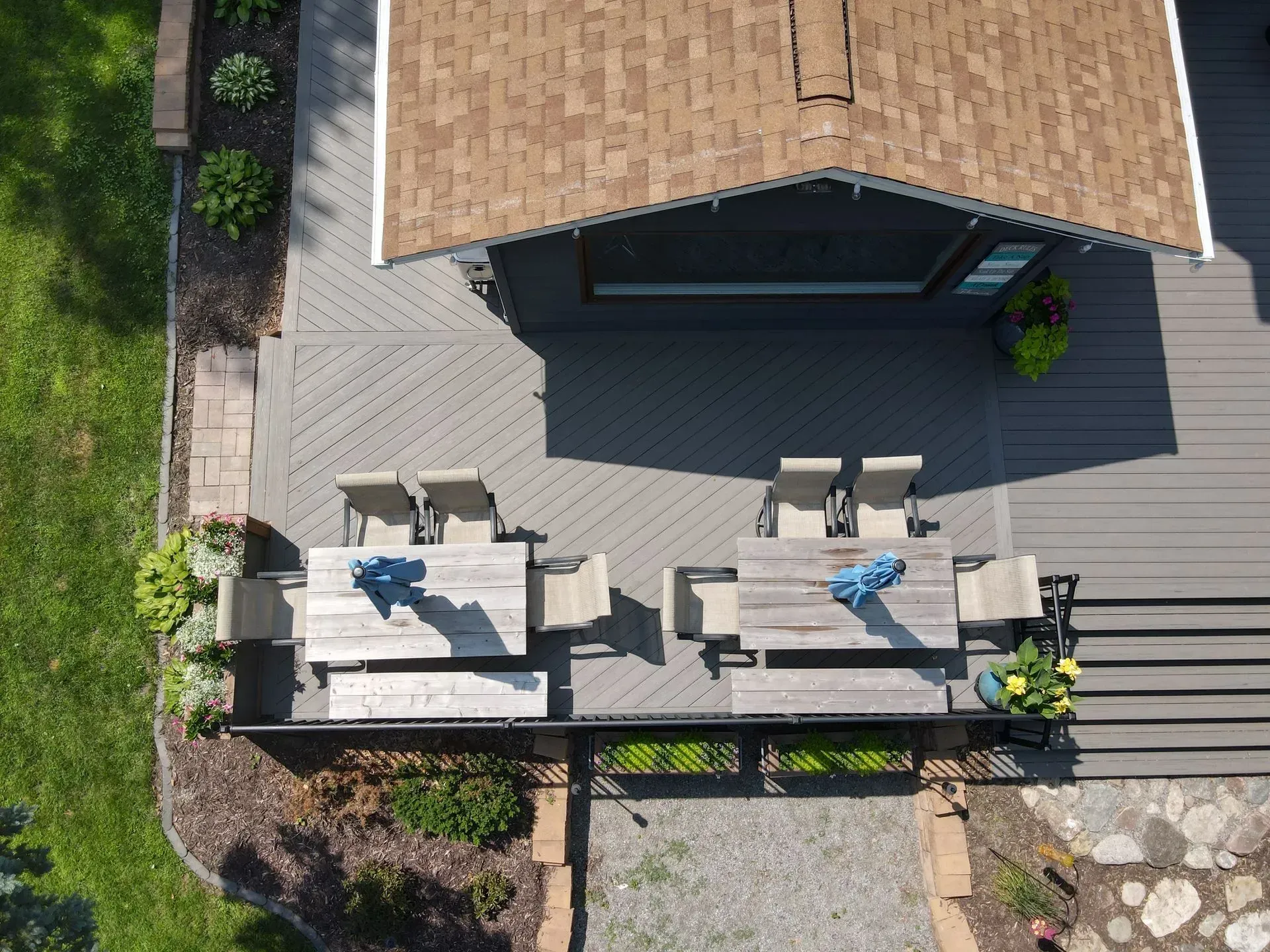 A house with a large deck and a blue cooler on it.