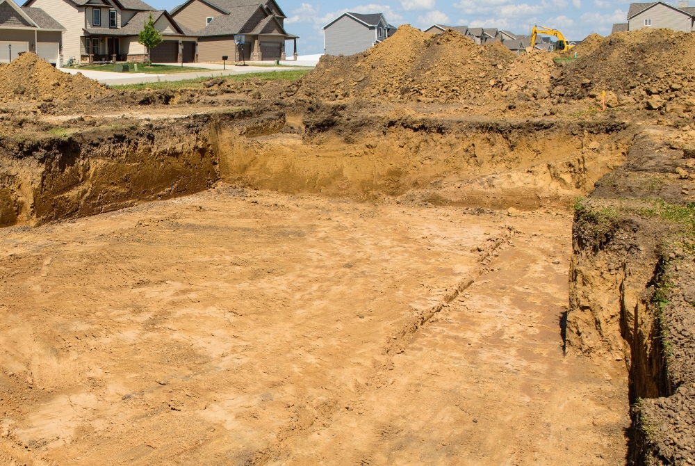 A large pile of dirt is sitting in front of a house