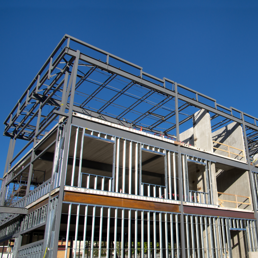 A building under construction with a blue sky in the background