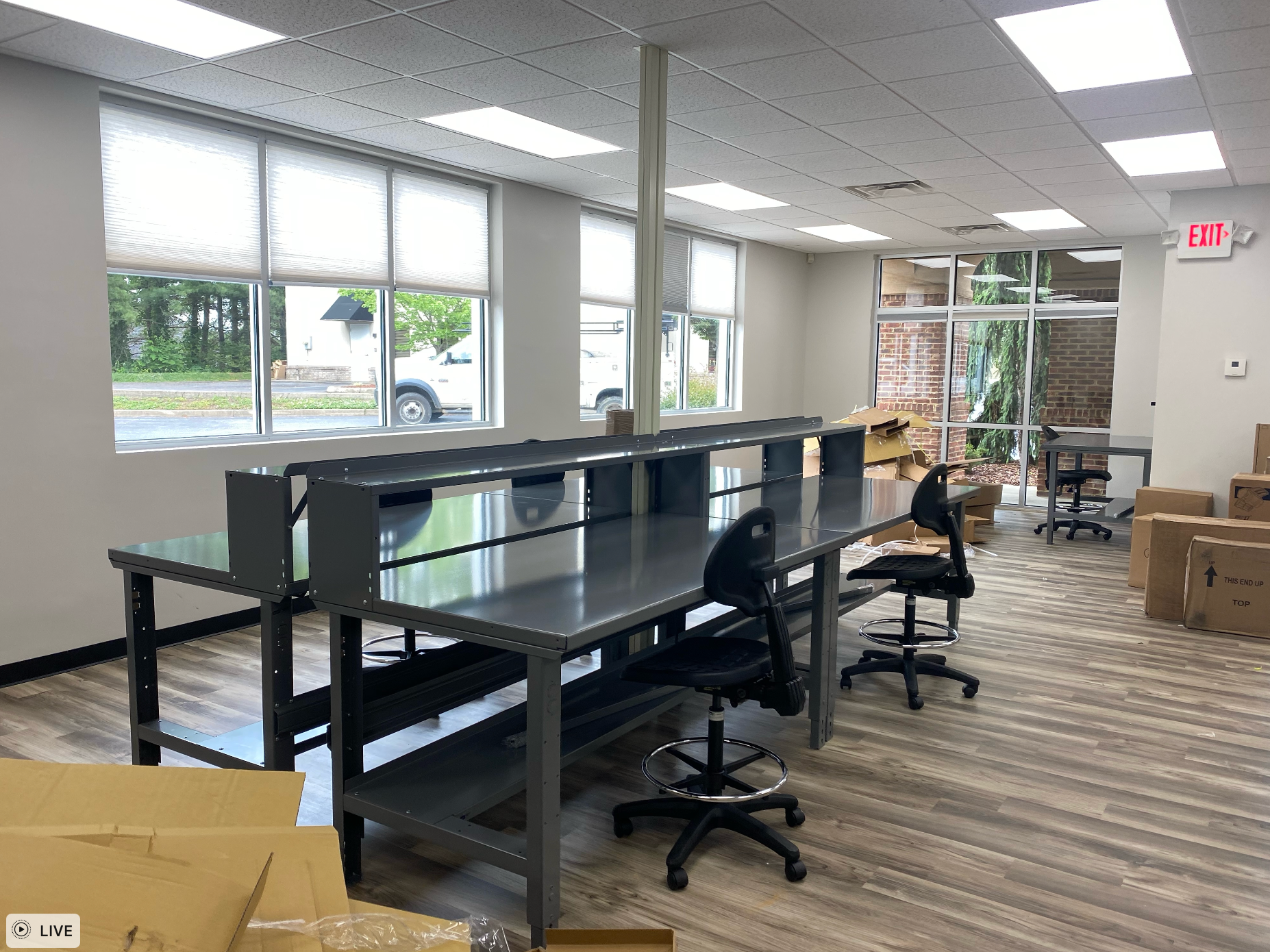A large room with a lot of new windows and tables and chairs remodeled by Hampton Construction & Development.