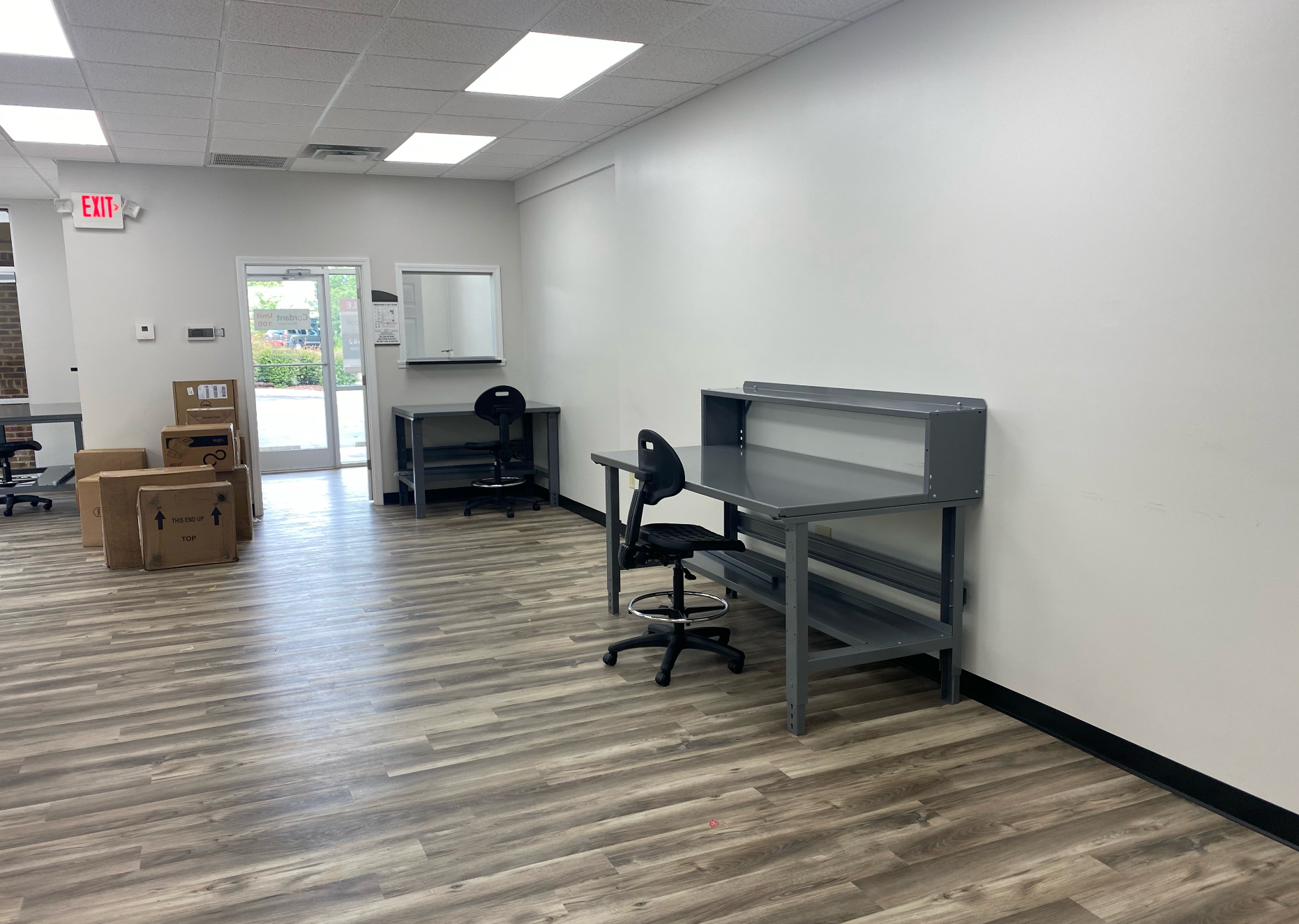 A large room with a desk and chairs in it remodeled by Hampton Construction & Development.