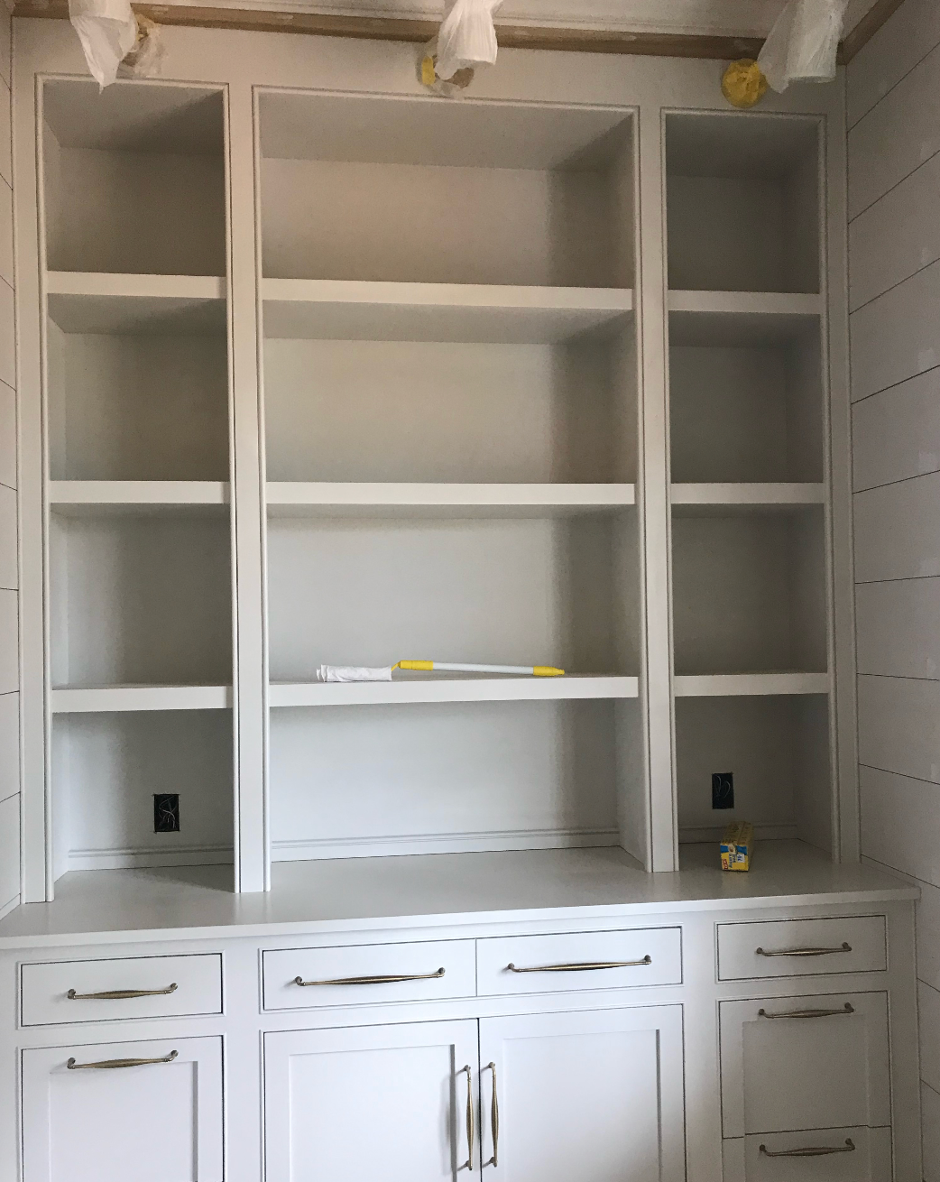 A room with a lot of shelves and drawers