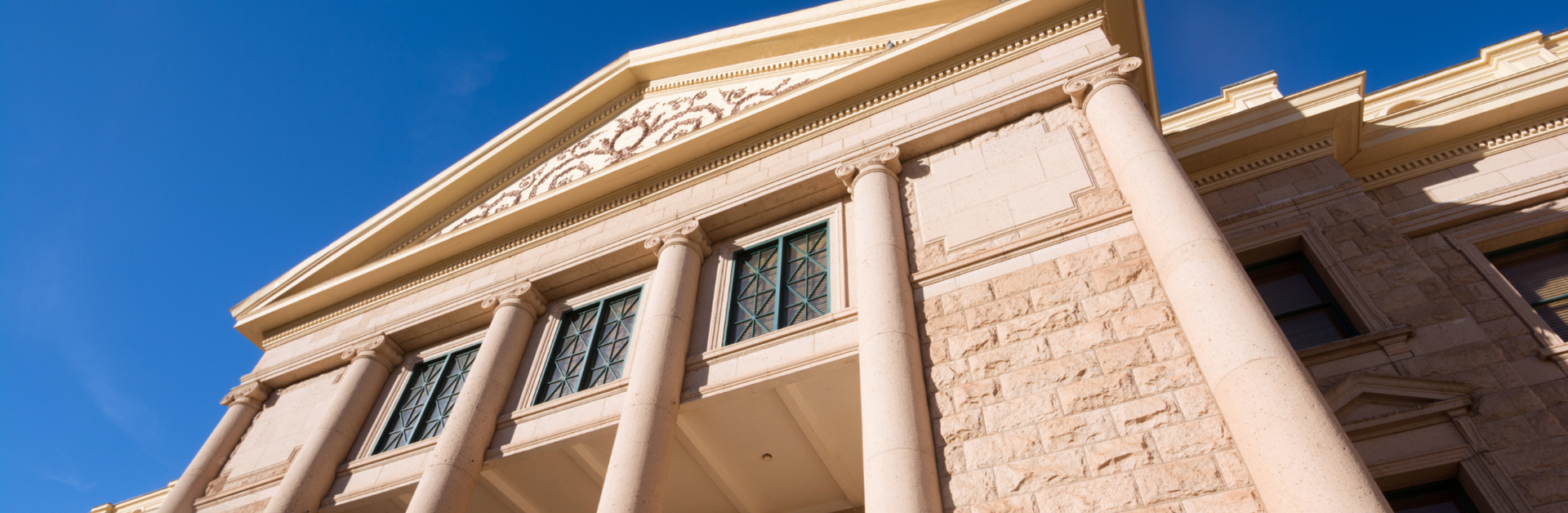 A shot of the Arizona State Capitol's exterior against the blue Arizona sky.