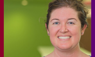 Smiling woman in front of a bright green background