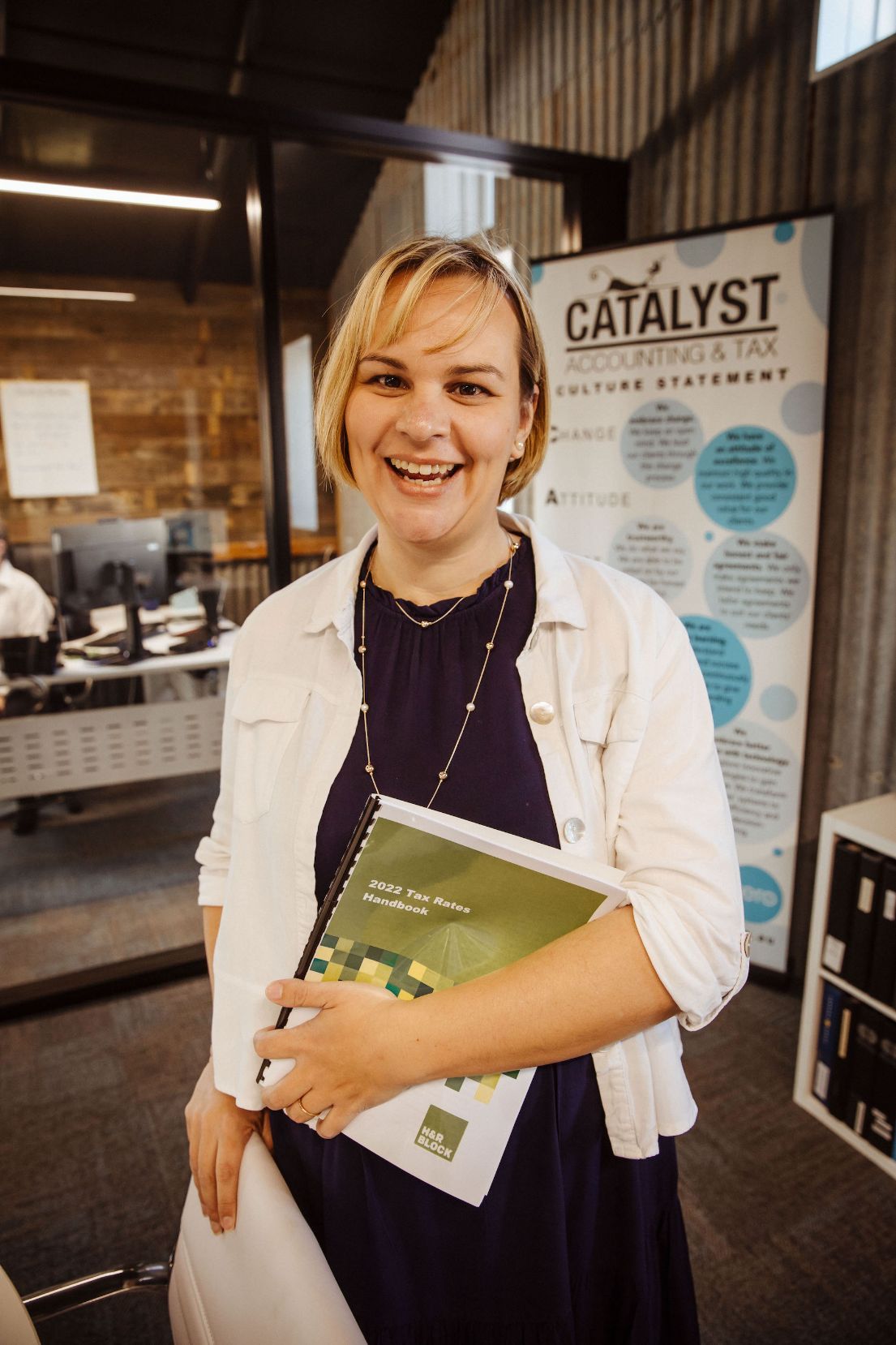Happy Amanda Holding A Tax Rates Handbook — Catalyst Accounting & Tax in Warwick, QLD