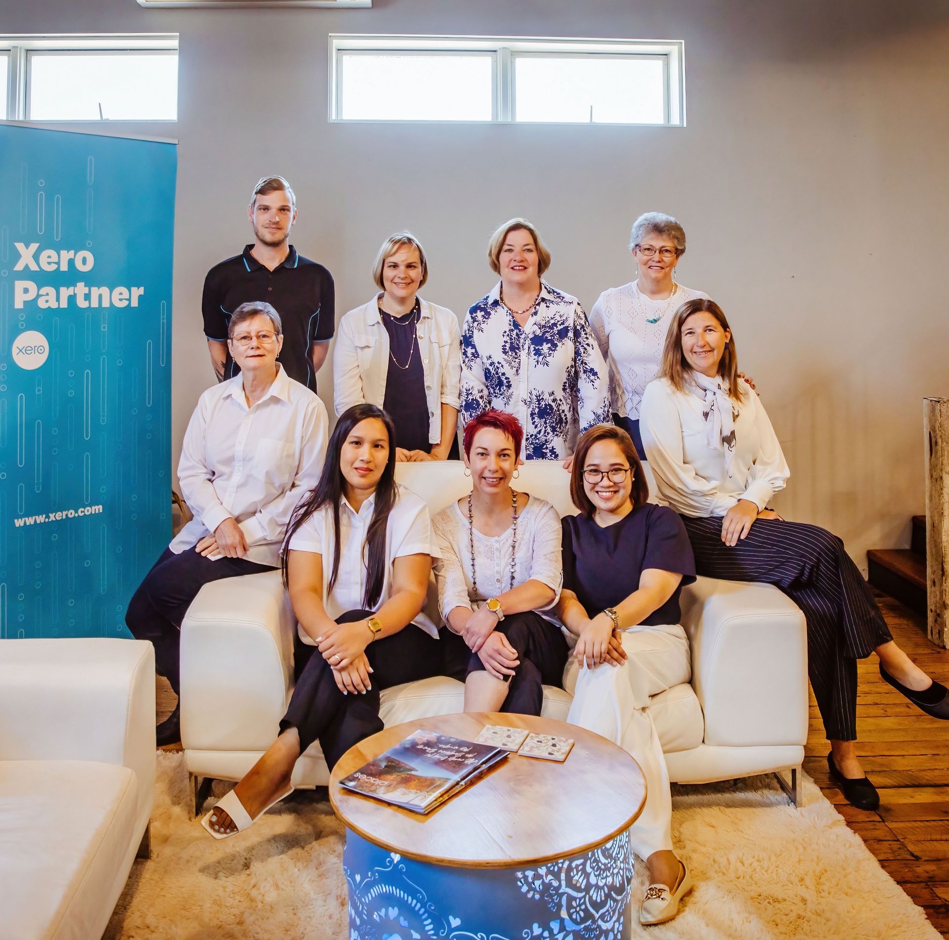 A Group of People Are Posing for A Picture While Sitting on A Couch — Catalyst Accounting & Tax in Warwick, QLD