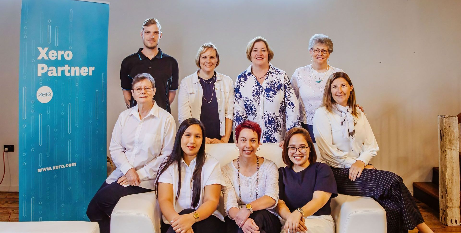 A Group of People Are Posing for A Picture While Sitting on A Couch — Catalyst Accounting & Tax in Warwick, QLD
