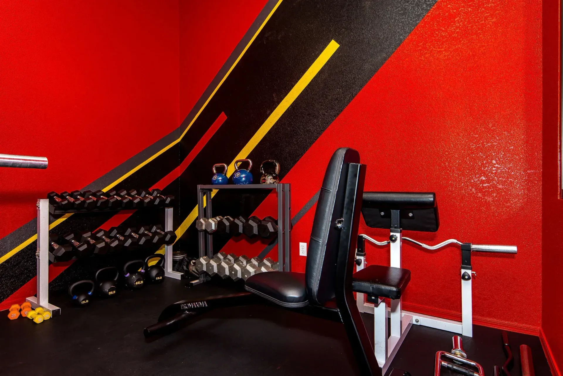 Form and Function Fitness gym in Fort Mohave, AZ with red walls, black floor, and exercise equipment including weights, benches, and battle ropes