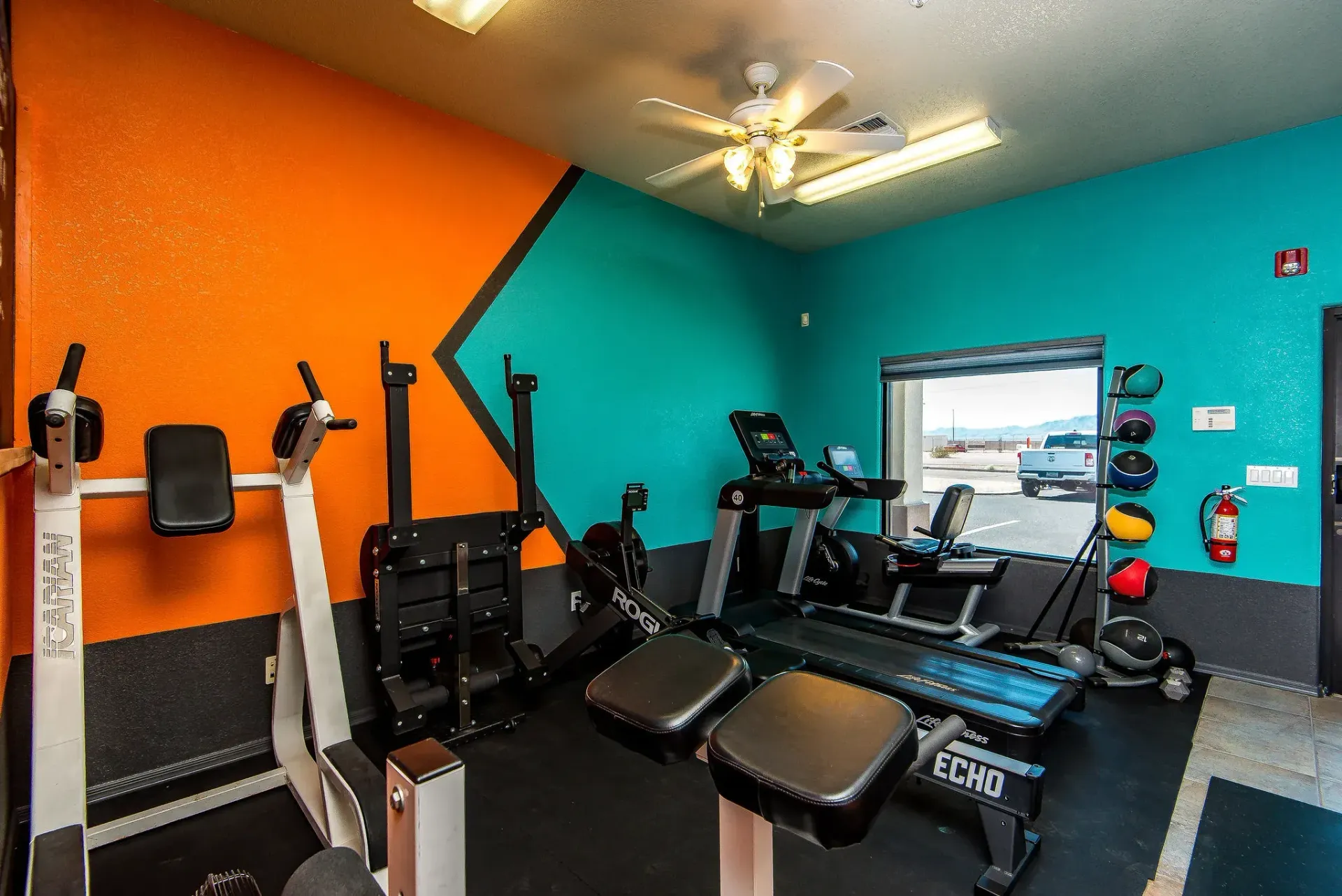 Form and Function Fitness gym in Fort Mohave, AZ with orange and teal walls, exercise machines, and a ceiling fan