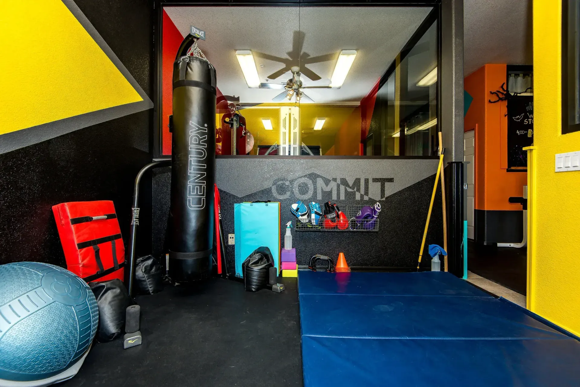 Form and Function Fitness gym in Fort Mohave, AZ, interior with punching bag, exercise ball, and blue mats on the floor